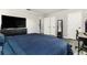 Cozy bedroom featuring plank flooring, a ceiling fan, closet, a large bed and ample storage, creating a relaxing space at 2443 Delrose E Dr, Lakeland, FL 33805