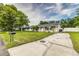 Traditional home with a large driveway and a well maintained lawn at 2443 Delrose E Dr, Lakeland, FL 33805