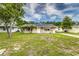 Beautiful single-story home with a green lawn, an inviting entrance and palm trees at 2443 Delrose E Dr, Lakeland, FL 33805