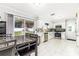 Bright kitchen featuring white cabinetry, stainless appliances, and a sliding glass door to the backyard at 2443 Delrose E Dr, Lakeland, FL 33805