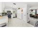 Well-lit kitchen with stainless steel appliances, white cabinets and views through to the living area at 2443 Delrose E Dr, Lakeland, FL 33805