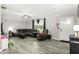 Cozy living room featuring modern gray flooring and comfortable, dark furniture set at 2443 Delrose E Dr, Lakeland, FL 33805