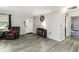 Open-concept living room boasts gray flooring, neutral walls, and a cozy armchair at 2443 Delrose E Dr, Lakeland, FL 33805