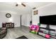 Bright and open living room with gray flooring and ample space for entertaining at 2443 Delrose E Dr, Lakeland, FL 33805