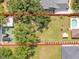 An overhead shot shows the backyard, pool, storage shed, and a glimpse of the neighboring homes at 2533 Peterson Rd, Lakeland, FL 33812
