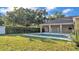 A lush, green backyard with a covered lanai and sparkling pool invites outdoor enjoyment at 2533 Peterson Rd, Lakeland, FL 33812