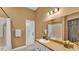 Bathroom featuring single sink vanity, framed mirror, shower with curtain and tiled floors at 2533 Peterson Rd, Lakeland, FL 33812