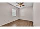 Bedroom featuring wood floor, ceiling fan and window with blinds at 2533 Peterson Rd, Lakeland, FL 33812
