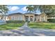 Elegant single-story home featuring manicured landscaping and a welcoming entrance with charming architectural details at 2533 Peterson Rd, Lakeland, FL 33812