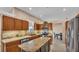 A kitchen featuring granite countertops, stainless steel appliances, and wood cabinets and eat in breakfast nook at 2533 Peterson Rd, Lakeland, FL 33812