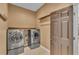 Laundry room with washer, dryer and hanging rack at 2533 Peterson Rd, Lakeland, FL 33812