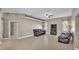 A comfortable living room offers tile floors, neutral walls, a ceiling fan, and comfortable leather furniture at 2533 Peterson Rd, Lakeland, FL 33812