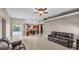 Spacious living room with tiled flooring seamlessly connects the kitchen, dining, and outdoor spaces at 2533 Peterson Rd, Lakeland, FL 33812