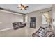 A cozy living room boasts tile floors, neutral walls, a ceiling fan and comfortable leather furniture at 2533 Peterson Rd, Lakeland, FL 33812