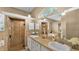 A well-lit bathroom featuring double sinks, a soaking tub, and a tiled walk-in shower at 2533 Peterson Rd, Lakeland, FL 33812