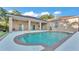 Beautiful backyard pool with a covered patio and landscaped surroundings at 2533 Peterson Rd, Lakeland, FL 33812