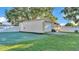 A large utility shed provides ample storage space with a roll up door and standard door at 2533 Peterson Rd, Lakeland, FL 33812