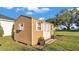 A charming backyard shed offers additional storage with a window AC unit at 2533 Peterson Rd, Lakeland, FL 33812