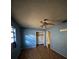 Bedroom features a ceiling fan, closet, window, and patterned flooring at 2921 Galaxy Ln, Lakeland, FL 33801