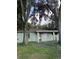 Single-story home with a simple design and trees in the front yard at 2921 Galaxy Ln, Lakeland, FL 33801