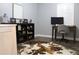 Bright bedroom with dark wood floors offers a built-in bookshelf and a desk setup for work at 301 Orange Blossom Dr, Winter Haven, FL 33880