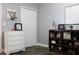 Comfortable bedroom featuring a dresser, closet, wood flooring, and tasteful decor at 301 Orange Blossom Dr, Winter Haven, FL 33880