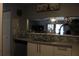 View of the kitchen features an open window to the living area at 301 Orange Blossom Dr, Winter Haven, FL 33880
