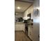 This bright kitchen features stainless steel appliances, light countertops, and tiled backsplash at 301 Orange Blossom Dr, Winter Haven, FL 33880