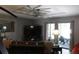 Spacious living room with a large TV, decorative lighting, and access to an outdoor area at 301 Orange Blossom Dr, Winter Haven, FL 33880