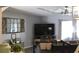 Well-lit living area with a home gym setup, TV, and view of outdoor scenery through the windows at 301 Orange Blossom Dr, Winter Haven, FL 33880