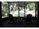 Relaxing screened patio features outdoor seating with views of the surrounding green space at 301 Orange Blossom Dr, Winter Haven, FL 33880