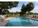 Community pool surrounded by lounge chairs and views of the water at 301 Orange Blossom Dr, Winter Haven, FL 33880
