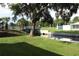Scenic waterfront view with mature trees and well-maintained grassy areas at 301 Orange Blossom Dr, Winter Haven, FL 33880