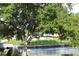 Lush trees surround the waterfront with a boat sitting by the water at 301 Orange Blossom Dr, Winter Haven, FL 33880