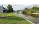 Waterfront view of a canal with lush vegetation and nearby buildings at 301 Orange Blossom Dr, Winter Haven, FL 33880