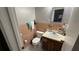 Functional bathroom with a single sink vanity and peach-colored tile, providing essential amenities in a compact space at 3100 Abaco St, Orlando, FL 32827
