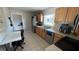 Well-lit kitchen featuring stainless steel appliances, wooden cabinets, and a functional layout with a view of the outdoors at 3100 Abaco St, Orlando, FL 32827