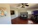 Comfortable living area featuring hardwood floors, a ceiling fan, and a view into the kitchen at 3100 Abaco St, Orlando, FL 32827