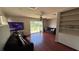 Cozy living room with hardwood floors, comfortable sofas, and a sliding glass door to the backyard at 3100 Abaco St, Orlando, FL 32827