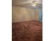 Cozy bedroom featuring patterned wallpaper, ceiling fan with light, and comfortable carpeting at 341 Sterling Dr, Winter Haven, FL 33884