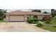 Single story home featuring a large driveway and attached garage at 341 Sterling Dr, Winter Haven, FL 33884