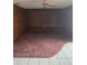 A living room with wood paneled walls, a ceiling fan and brown carpet at 341 Sterling Dr, Winter Haven, FL 33884