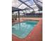 Covered backyard pool with patio, fence, and ladder for summer enjoyment at 341 Sterling Dr, Winter Haven, FL 33884