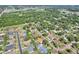 An aerial view shows a home in a residential area surrounded by tree-lined streets and lush greenery at 3522 Royal S Ct, Lakeland, FL 33812