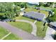 An aerial view of home with an ample yard, shed, and curving driveway situated on a peaceful street at 3522 Royal S Ct, Lakeland, FL 33812
