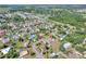 An aerial view of a home with swimming pool, and mature trees within a neighborhood near a pond at 3522 Royal S Ct, Lakeland, FL 33812