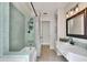 Well-lit bathroom featuring tile accents, a shower/tub, a spacious vanity, and storage for a spa-like experience at 3522 Royal S Ct, Lakeland, FL 33812
