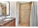 Bathroom featuring a vanity with granite countertop and a tiled walk-in shower at 3522 Royal S Ct, Lakeland, FL 33812