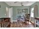 Charming Bedroom featuring a wooden crib, rocking chair, and built-in shelving for organized storage at 3522 Royal S Ct, Lakeland, FL 33812