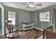 Bright Bedroom with hardwood floors, two windows, and a changing table for baby care at 3522 Royal S Ct, Lakeland, FL 33812